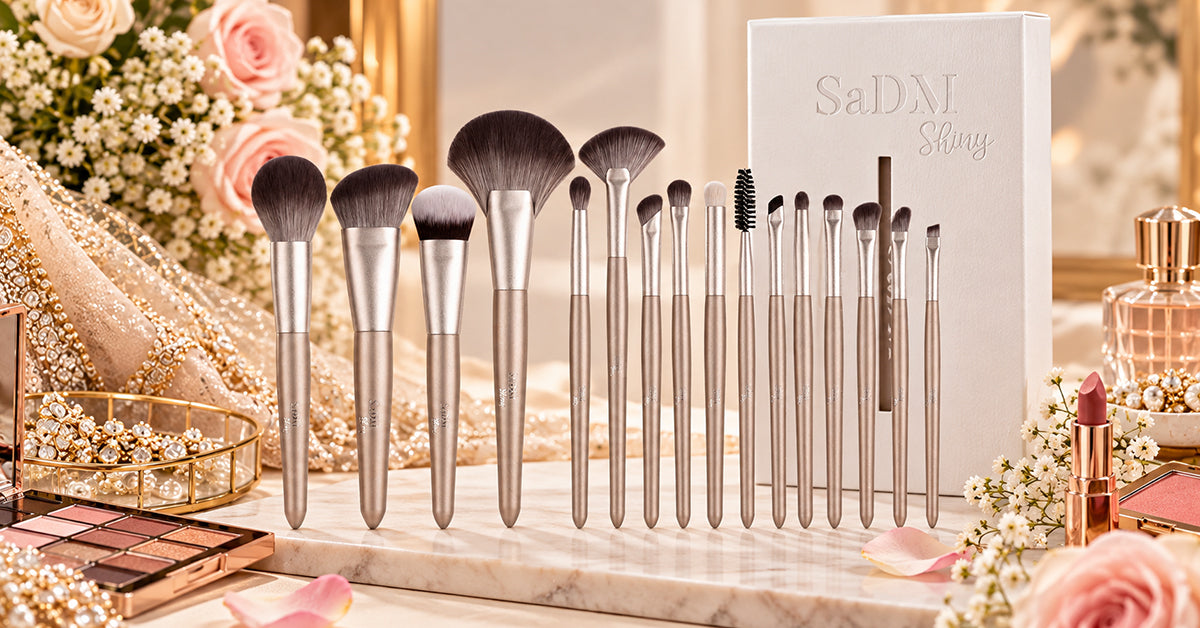 Flat lay of bridal makeup brushes and cosmetics arranged beside a wedding veil