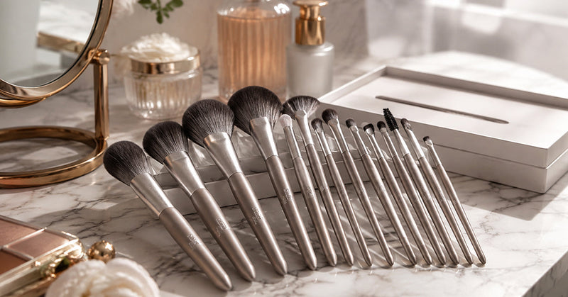 Flat lay of essential face makeup brushes for foundation, blush, bronzer, and powder arranged on a vanity