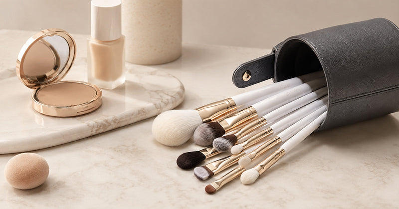 Woman applying foundation with a makeup brush, focusing on blending for a smooth finish