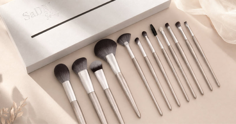 Selection of angled and fluffy blush brushes next to powder blushes on a vanity