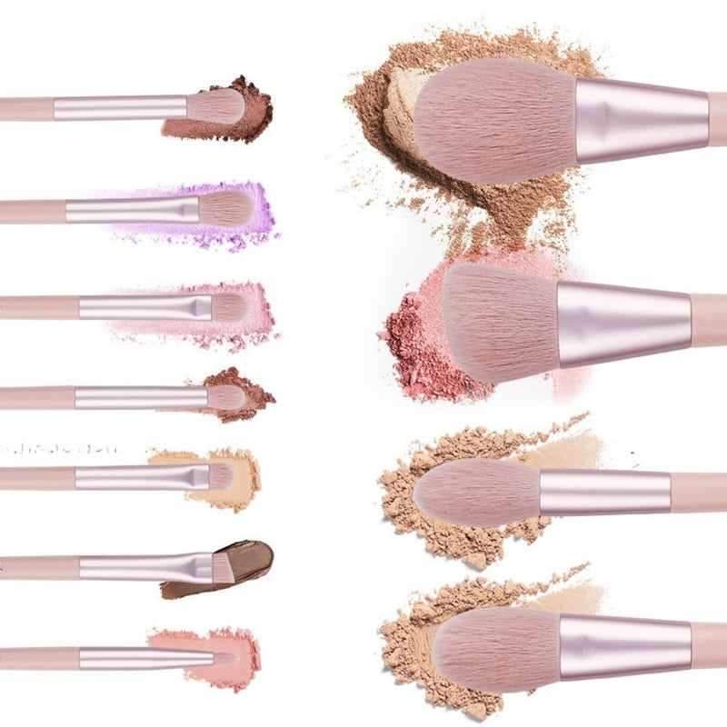 Pink makeup brushes with soft bristles shown beside swatches of powder, blush and eyeshadow